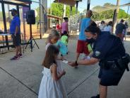 Officer hands out stickers at egg hunt