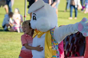 a child poses for a photo with the easter bunny 