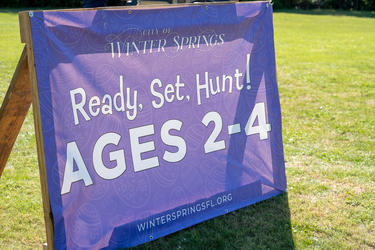 a purple sign with white letters that says ready set hunt ages 2-4 